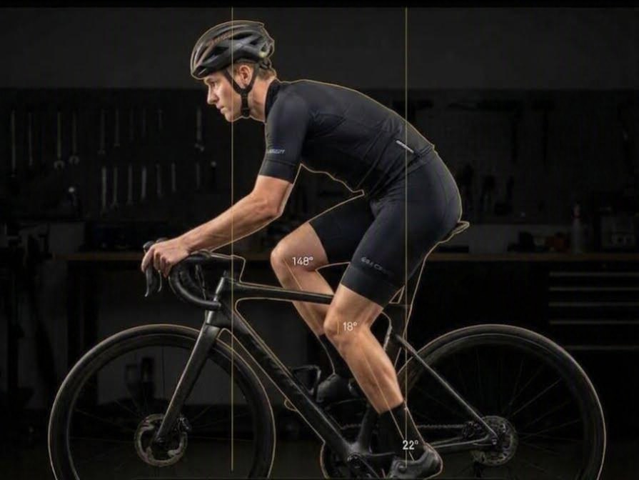 Llyr's bike fit screen: a rider filmed square side-on with the app's own lines traced along his body and hip, knee and ankle angles written beside the working leg.